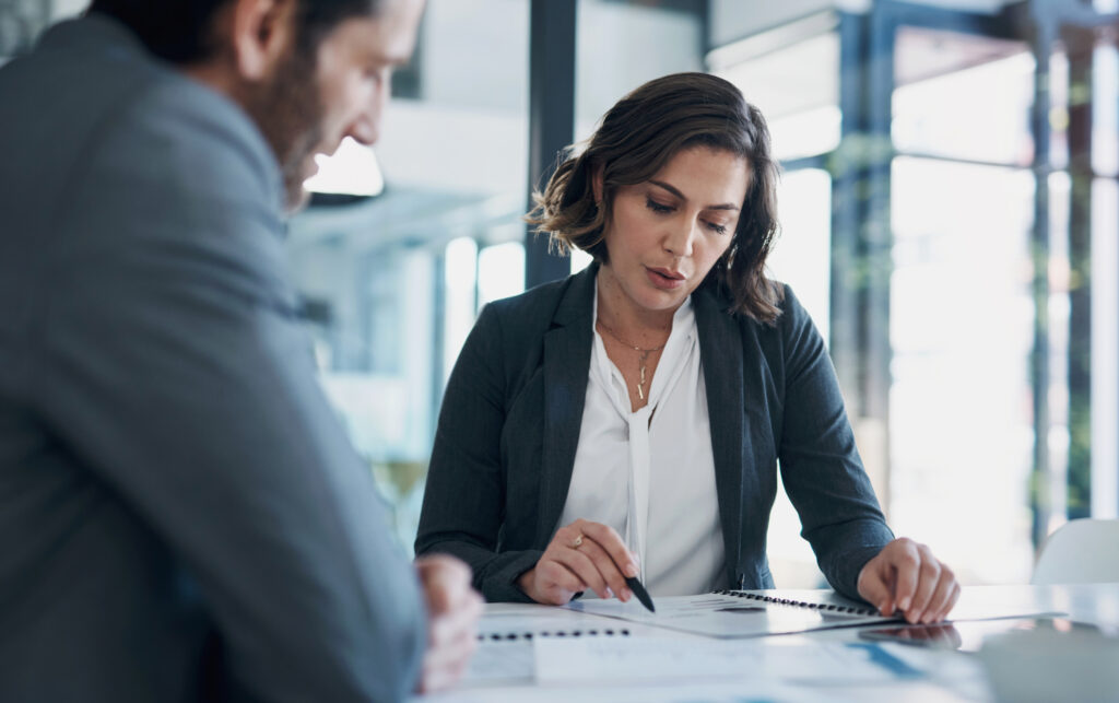 Two business professionals reviewing documents together at a desk